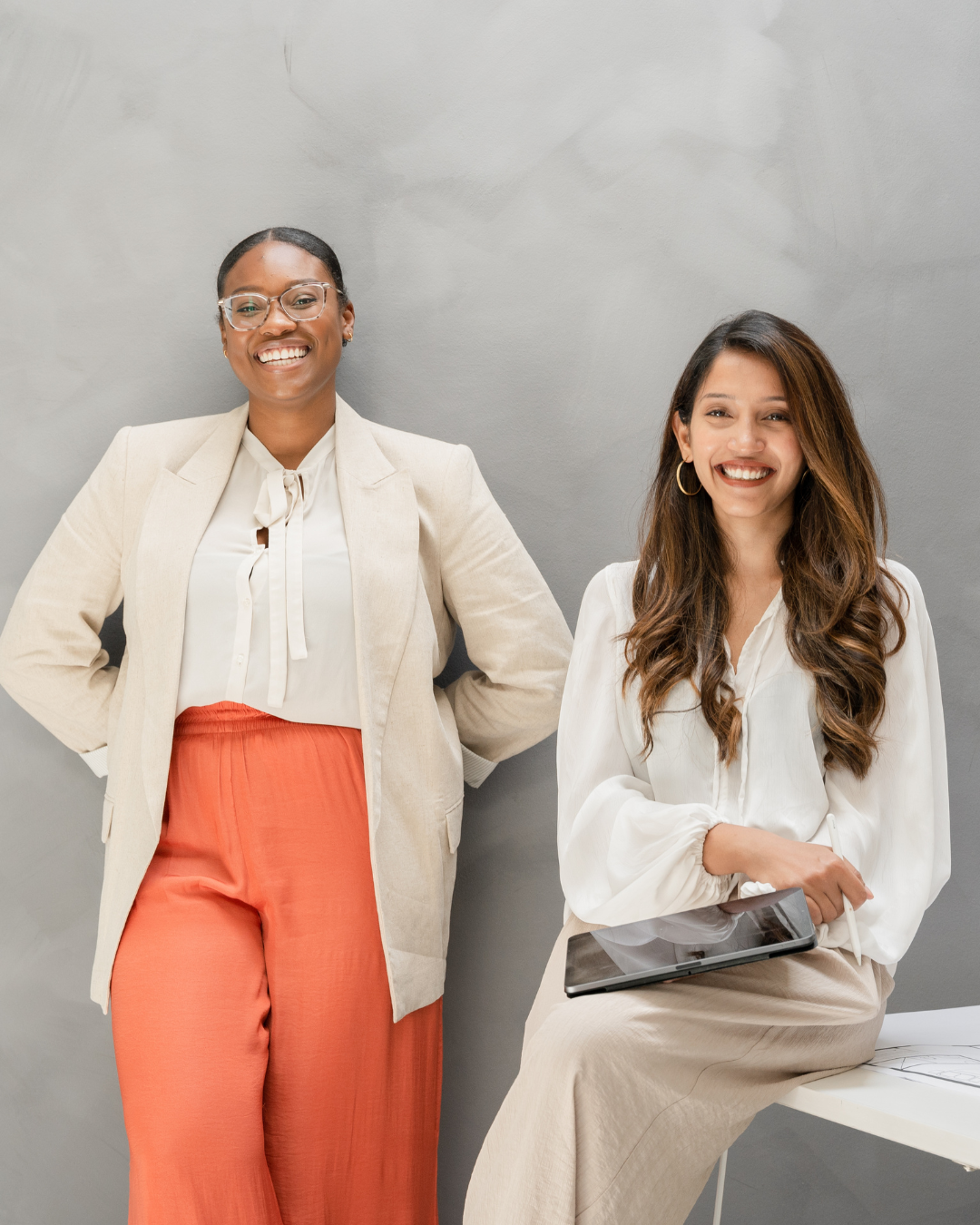 Two business women smiling who are interested in SEO Power Hour services.